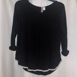 Black blouse with white pom pom along the back and bottom size small